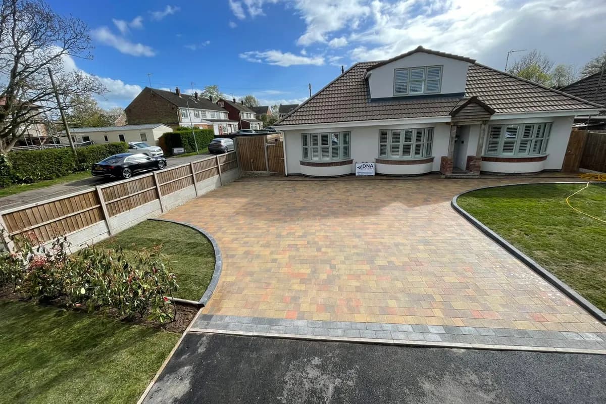 A finished block paved driveway with curved edging in front of a bungalow in Binley Woods